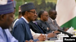 Nigerian President Muhammadu Buhari, second left, talks with Chinese officials during a meeting at the Great Hall of the People in Beijing, April 13, 2016.