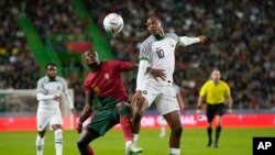 Portugal's Nuno Mendes challenges Nigeria's Joseph Ayodele-Aribo for the ball during an international friendly at the Jose Alvalade stadium in Lisbon, November 17, 2022. 