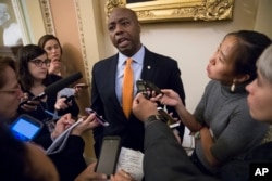 FILE - Sen. Tim Scott, R-S.C., talks to reporters about his plan to meet with President Donald Trump to discuss race and Trump's widely criticized response to last month's protests and racial violence in Charlottesville, Virginia, in Washington, Sept. 13, 2017.