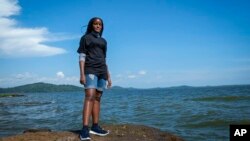 Ugandan climate activist Vanessa Nakate poses for a photograph on the shore of Lake Victoria on the outskirts of Kampala, Uganda, Dec. 6, 2021. 