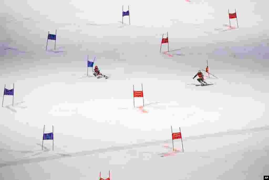 Austria&#39;s Christian Hirschbuehl, left, competes alongside Norway&#39;s Henrik Kristoffersen during an alpine ski men&#39;s World Cup parallel event, in Lech/Zuers, Austria.