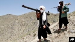 FILE - Members of a breakaway faction of the Taliban fighters gather in Shindand district of Herat province, Afghanistan, May 27, 2016.