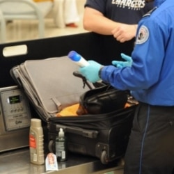 A Transportation Security Administration officer finds unallowable liquids in a passenger's carry-on luggage at Hartsfield-Jackson Atlanta International Airport. The TSA was created after the September 11 terrorist attacks.