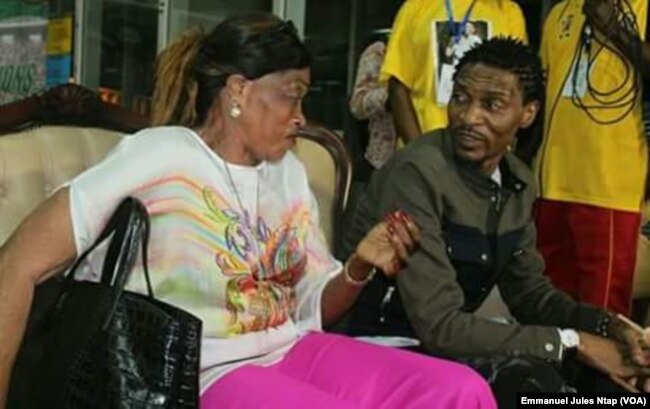 Rigobert Song est accueilli en conversation avec sa mère Bernadette, dans le salon VIP de l’aéroport de Yaoundé, 1er avril 2017. (VOA/Emmanuel Jules Ntap)