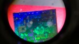  FILE - A Chinese microchip is seen through a microscope at the 21st China Beijing International High-tech Expo in Beijing on May 17, 2018. 