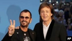 Musicians and members of the Beatles, Paul McCartney, right, and Ringo Starr pose for photographers upon arrival at the World premiere of the Beatles movie, Ron Howard's 'Eight days a week-the touring years' in London, Thursday, Sept. 15, 2016. 