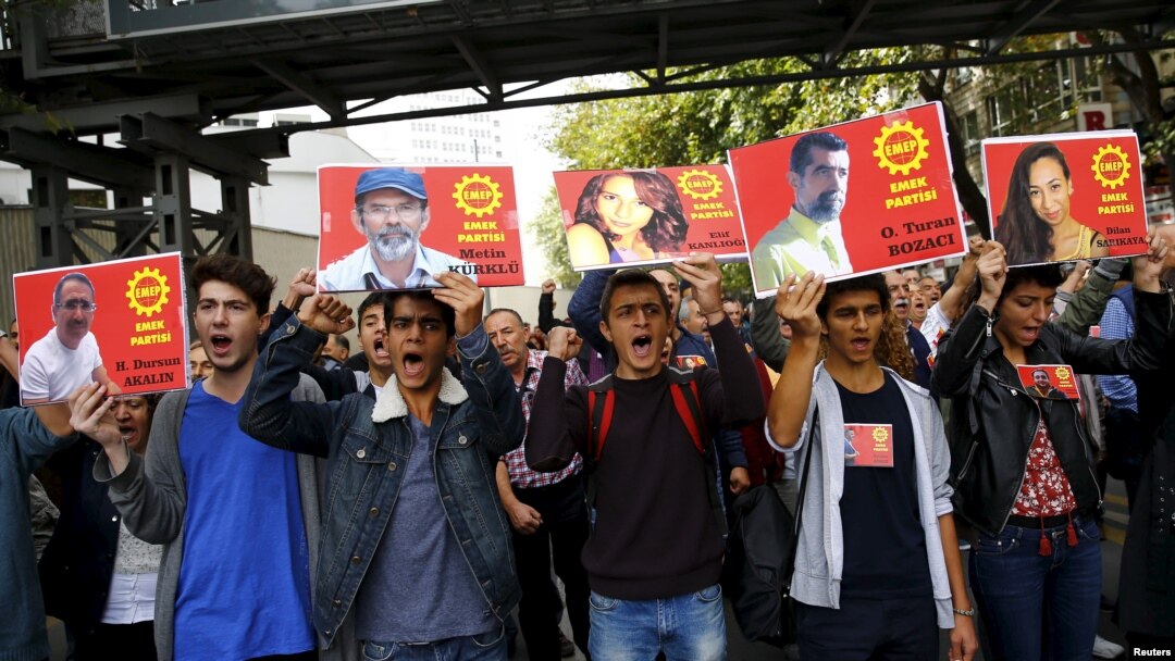 Members of the left-wing Labour Party (EMEP) carry pictures of the victims of Saturday's bomb blasts during a commemoration in Ankara, Oct. 11, 2015.