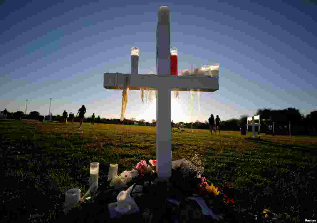Candle drippings hang off one of 17 crosses at a memorial for the victims of the shooting at Marjory Stoneman Douglas High School in Parkland, Florida, Feb. 16, 2018.
