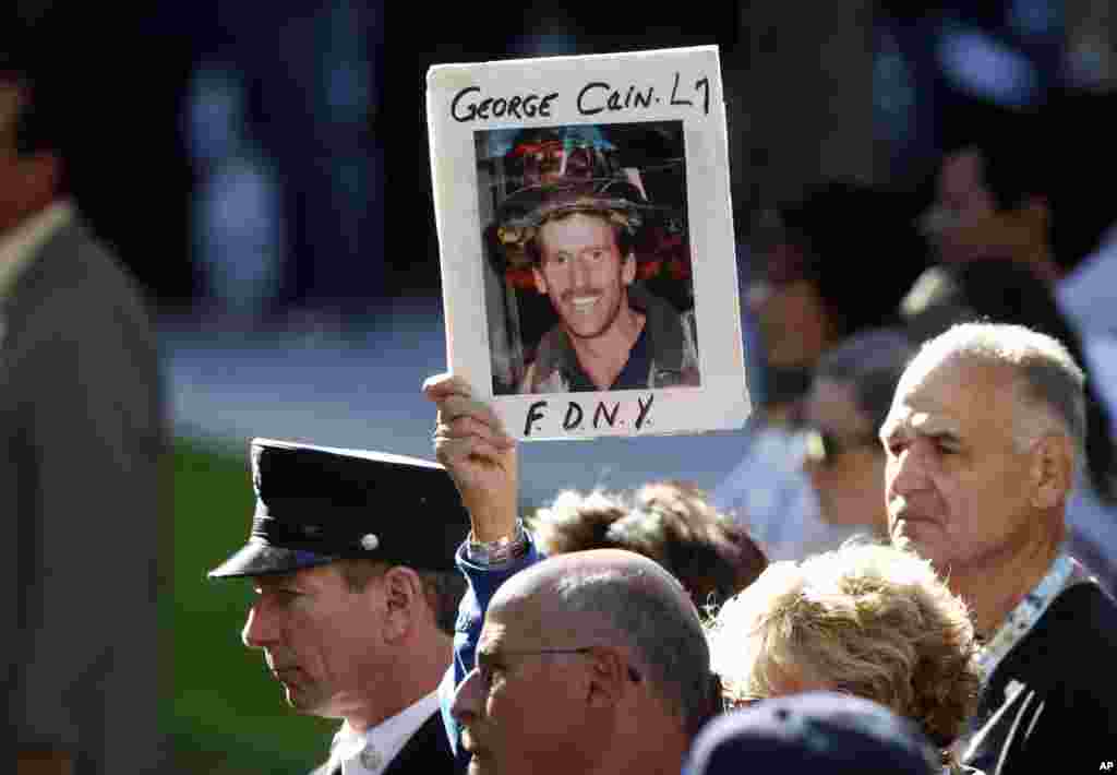 Friends and relatives of the victims of the September 11 terrorist attacks attend a ceremony at the National September 11 Memorial at the World Trade Center site in New York, September 11, 2012.