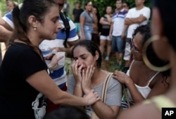 Residents react with relief after learning that their relatives survived the two collapsed buildings in the Muzema neighborhood, Rio de Janeiro, Brazil, April 12, 2019.