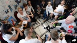 Former Polish president and anti-communist leader Lech Walesa, right, meeting with disabled people and their parents to offer them solidarity on the 34th day of their sit-in at the parliament in demand for more state aid, at the parliament building in War