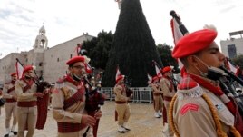 Members of a Palestinian marching band parade at Manger Square, in Bethlehem in the Israeli-occupied West Bank November 28, 2020. (REUTERS/Mussa Qawasma)