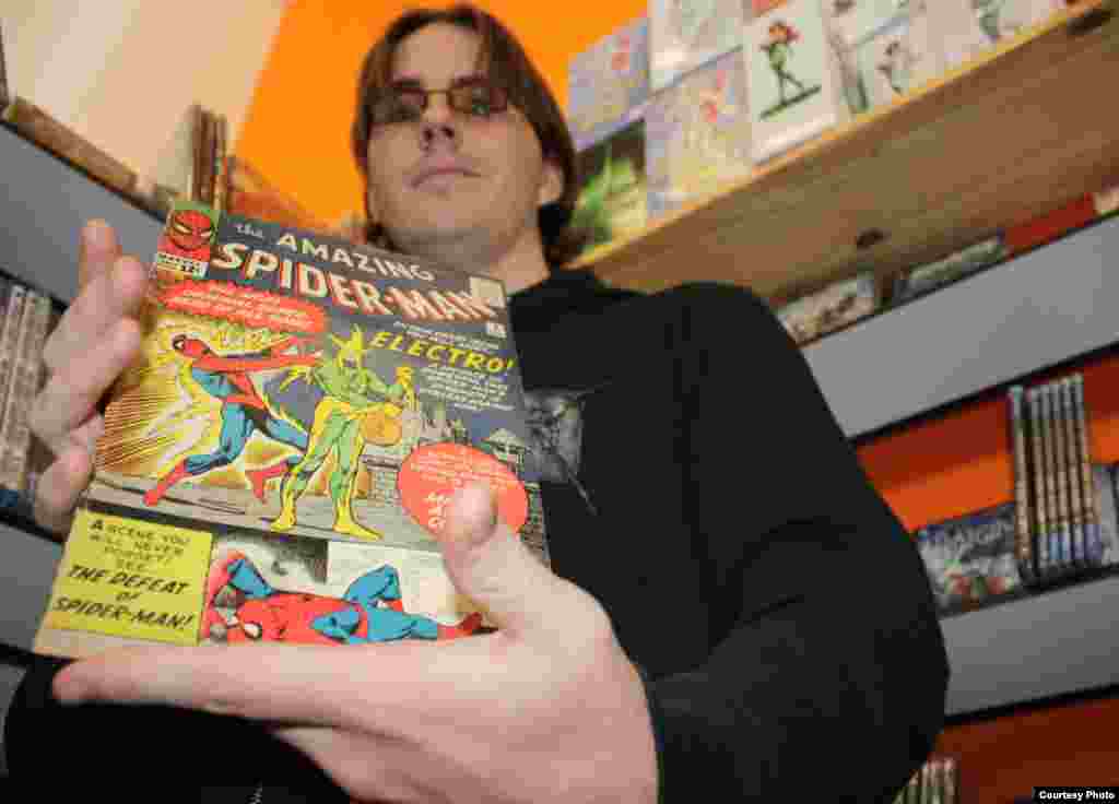 Comic book expert Scot Brimson holds a rare edition of a Spider Man comic from the early 1960s, priced under $600. Brimson also sells the latest in comics at Cosmic Comics, a Johannesburg store sandwiched between a bakery and a tire fitment center. Photo by Darren Taylor.