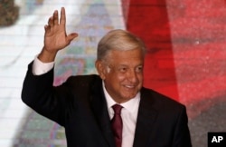 Presidential candidate Andres Manuel Lopez Obrador waves to supporters as he gives his first victory speech from his campaign headquarters in Mexico City, July 1, 2018.