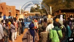 People gather outside a hospital were injured were taken after a suicide bomber in an explosives-laden vehicle attacked the Joint Operational Mechanism base in Gao, Mali, Jan. 18, 2017.