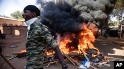 Protesters take to the streets of Burkina Faso's capital, Ouagadougou, Nov. 27, 2021, calling for President Roch Marc Christian Kabore to resign. 