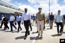 This photo provided by the Dutch Defense Ministry shows Dutch King Willem-Alexander, center right, visiting after the passing of Hurricane Irma, in Dutch Caribbean St. Maarten, Sept. 11, 2017.