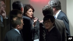 U.S. Ambassador to the United Nations Nikki Haley, center, confers with members of the Security Council before a scheduled vote on a resolution demanding a 30-day humanitarian cease-fire across Syria, Feb. 24, 2018.