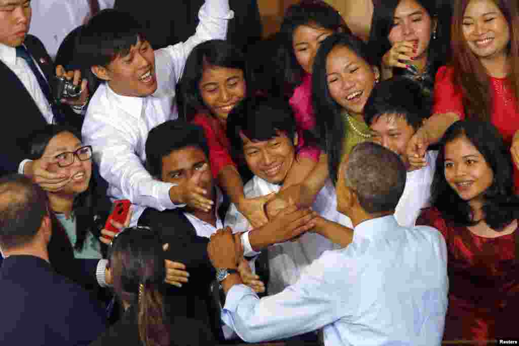 Youths reach to shake hands with U.S. President Barack Obama after his speech at a YSEALI (Young Southeast Asian Leaders Initiative) Town Hall at Yangon University in Yangon, Nov. 14, 2014.