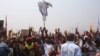 Supportes of Congo opposition leader Etienne Tshisekedi, rear, hold up a cross that symbolizes no third term for Congo President Joseph Kabila, during a political rally in Kinshasa, Congo, Wednesday, July 31, 2016.