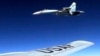 In this image released by the U.S. Air Force, a U.S. RC-135 flying in international airspace over the Baltic Sea is intercepted by a Russian SU-27 jet, June 19, 2017. The Russian military said it scrambled a fighter jet to intercept and escort a U.S. strategic bomber flying over the Baltic along the Russian border. 