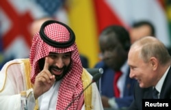 FILE - Saudi Arabia's Crown Prince Mohammed bin Salman speaks with Russia's President Vladimir Putin during the opening of the G-20 leaders summit in Buenos Aires, Argentina, Nov. 30, 2018.