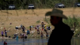 Migrants, many from Haiti, wade across the Rio Grande from Del Rio, Texas, to return to Ciudad Acuna, Sept. 22, 2021, some to avoid possible deportation from the U.S. and others to get supplies.