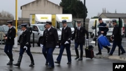 French gendarmes arrive for a ceremony for their slain colleague Lieutenant-Colonel Arnaud Beltrame at the airport in Carcassonne on March 27, 2018. 