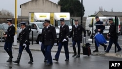 French gendarmes arrive for a ceremony for their slain colleague Lieutenant-Colonel Arnaud Beltrame at the airport in Carcassonne on March 27, 2018, from where his body is scheduled to be transported to a national ceremony to be held in Paris on March 28.