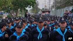 Police surround the Dhammakaya sect temple in Pathum Thani, north of Bangkok, Thailand, Feb. 19, 2017.