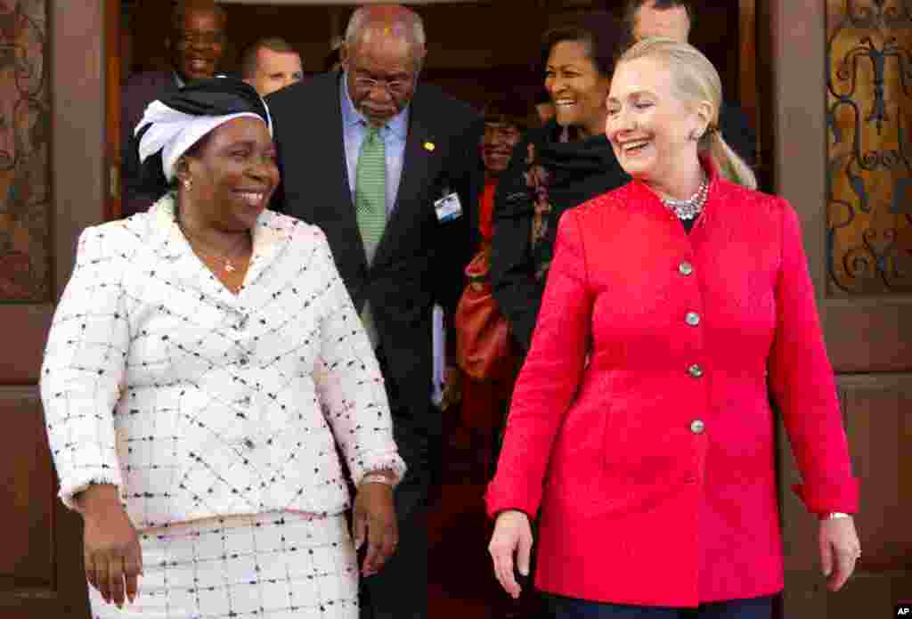Hillary Clinton walks out with African Union Chair-Designate Nkosazana Dlamini-Zuma after their meeting at Brynterion Estate in Pretoria, South Africa, August 7, 2012.