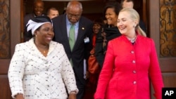 Secretary of State Hillary Rodham Clinton walks out with then African Union Chair-Designate Nkosazana Dlamini-Zuma after their meeting in Pretoria, South Africa, Aug. 7, 2012. 