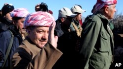 FILE - Iraqi Kurdistan President Massoud Barzani (L) is seen in a Dec. 21, 2014, photo in the town of Sinjar, Iraq.