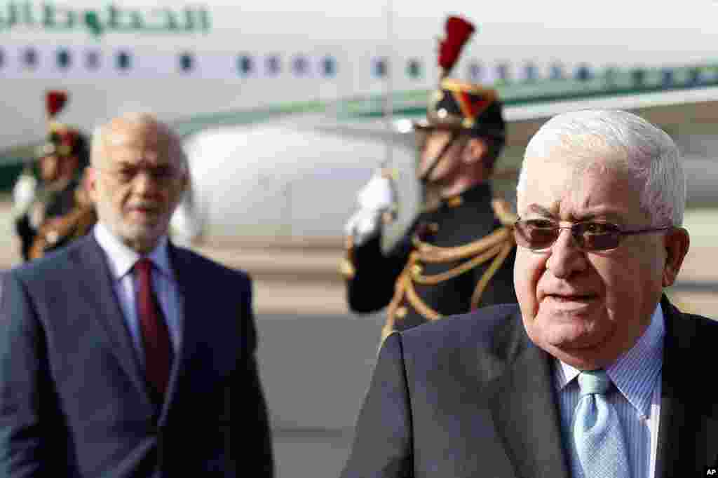 Iraq President Fouad Massoum (right) followed by Iraq Foreign Minister Ibrahim Al-Jaafari arrive with Iraqi officials for a conference aimed at helping Iraq fight off extremists from the Islamist State, at Orly airport, south of Paris, France, Sept. 15, 2014.