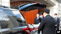 Officials move the body of former South Korean President Chun Doo-hwan from his house to a funeral hall in Seoul, South Korea, Nov. 23, 2021.