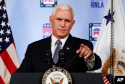 FILE - Vice President Mike Pence gestures while speaking in Washington, Aug. 24, 2018. President Donald Trump is lashing out against the anonymous senior official who wrote an opinion piece in The New York Times about his administration. Swift denials of involvement in the op-ed have come from Pence, Secretary of State Mike Pompeo and Dan Coats, director of national intelligence, among others.