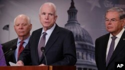 Senate Armed Services Committee Chairman Sen. John McCain, R-Ariz., flanked by Sen. Ben Cardin, D-Md., left, and Sen. Bob Menendez, D-N.J., speaks during a news conference on Capitol Hill, Jan. 10, 2017, to announce legislation lawmakers are introducing t