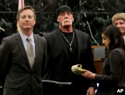 In this March 21, 2016 photo, Hulk Hogan, whose given name is Terry Bollea, center, looks on in court moments after a jury returned its decision in St. Petersburg, Fla.