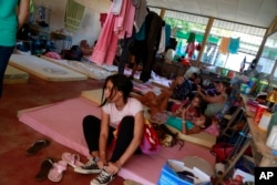 Cuban migrants relax at a temporary shelter in La Cruz, Costa Rica, Jan. 12, 2016.