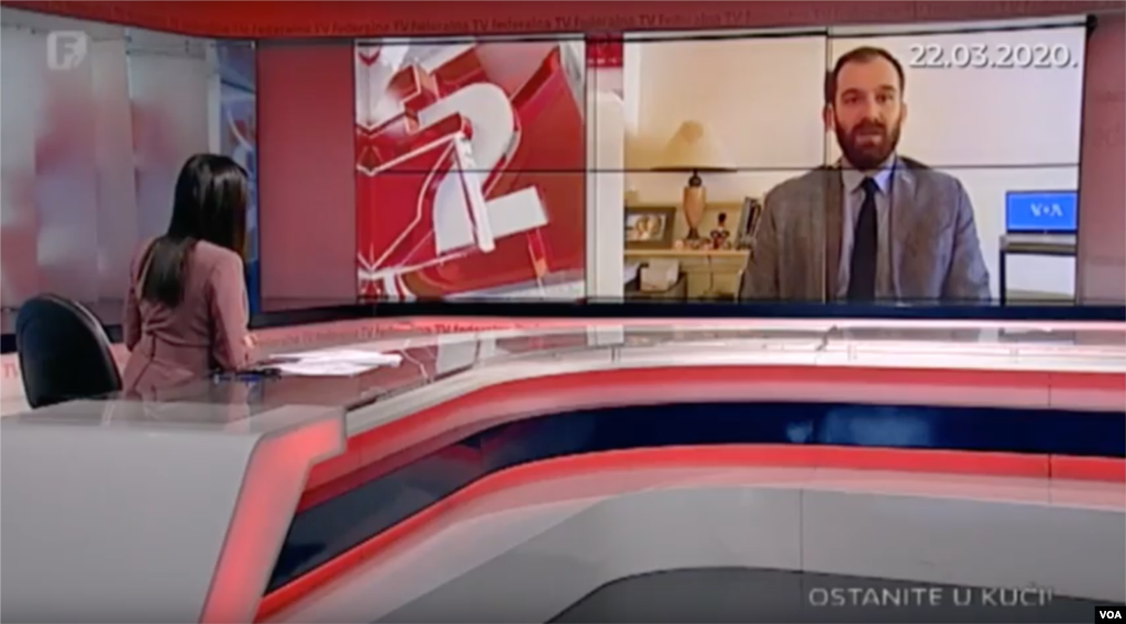 Transforming his living room into a self-isolation studio for live TV interviews to affiliate stations in Bosnia, VOA’s Bosnian service journalist, Dino Jahic, uses his ironing board to double as an anchor desk to set up an in-home camera on his laptop for live broadcasts.