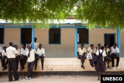 FILE - Students take a break at Supiri Secondary School in Juba, South Sudan. The school is mixed boys and girls. Some women's rights activists believe that only through educating girls will sexual violence in South Sudan end. (UNESCO/B. Desrus)