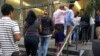 FILE - People line up outside the building that houses the immigration courts in Los Angeles, June 28, 2018.