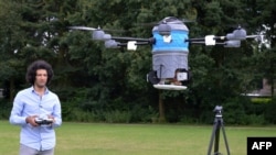 A picture taken July 4, 2016, shows Afghan refugee Massoud Hassani flying an anti-land-mine drone, called the Mine Kafon Drone, in Eindhoven, the Netherlands.