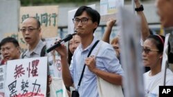 Land reform campaigner Eddie Chu, center, speaks as he thanks his supporters for their vote in the legislative elections in Hong Kong, Sept. 10, 2016.