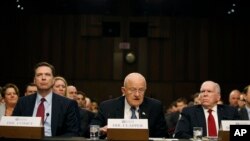 FILE - From left, FBI Director James Comey, Director of the National Intelligence James Clapper, CIA Director John Brennan, participate in the Senate Intelligence Committee's hearing on worldwide threats, Feb. 9, 2016, on Capitol Hill in Washington.