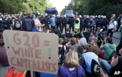 Protesters block a road during the G-20 summit in Hamburg, Germany, July 8, 2017.