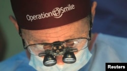 Operation Smile co-founder Bill Magee performs a facial deformity repair surgery for a patient, at the Vietnam Cuba hospital in Hanoi, Nov. 18, 2014.