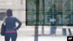 A stock exchange monitor displays the market trends in Milan, Italy, November 9, 2011.