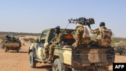 Des membres de l'Armée malienne (FAMA), du Groupe Autodefense Touareg Imghad et Alliés (GATIA) et du Mouvement pour le salut de l'Azawad (MSA) sont observés lors d'une patrouille mixte dans les environs du district du nord du Mali. de Meneka dans le distr