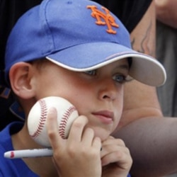 New York Mets fan Stephen LaGrua, 8, waits to get an autograph signed before an opening day baseball game between the Florida Marlins and the Mets in Miami, Friday, April 1, 2011